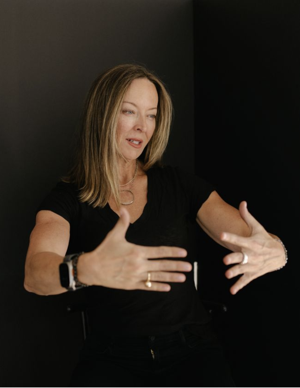 Anese Cavanaugh gesturing with both hands open while speaking
